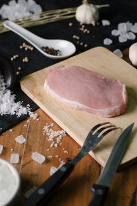 High angle view of meat on cutting board