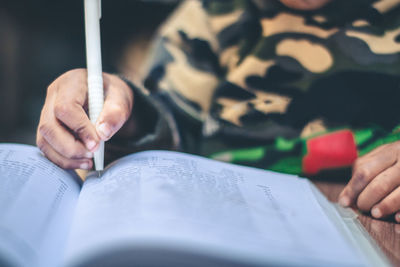 Close-up of hand holding book