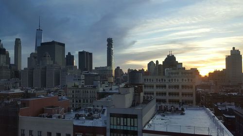 View of cityscape against cloudy sky