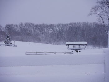 Snow covered field against sky