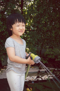 Full length of cute girl standing in yard