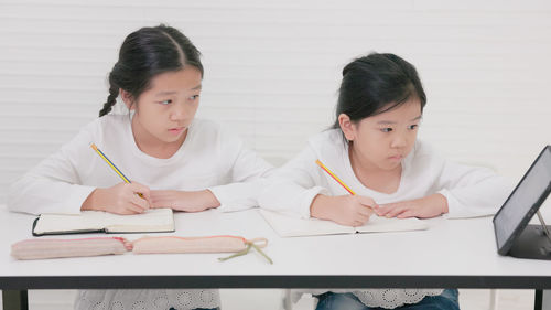 In tutorial school, asian students learn to write in both english and chinese.