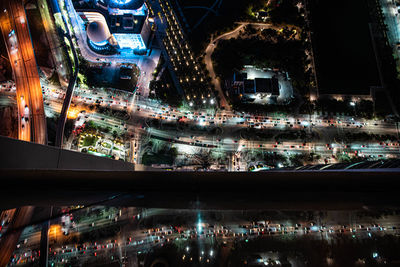 High angle view of illuminated street and buildings at night