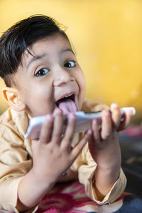 Portrait of cute boy holding baby