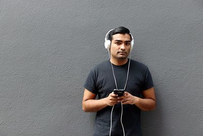 Portrait of young man using phone in city