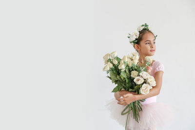 Woman holding bouquet of rose against white background