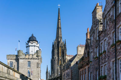 Low angle view of the hub in city against clear blue sky