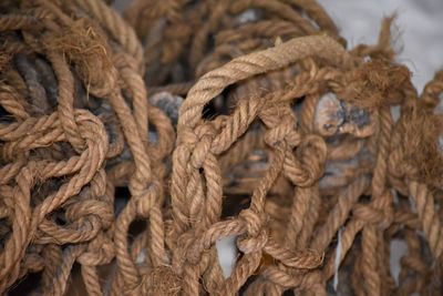 Close-up of brown ropes on metal