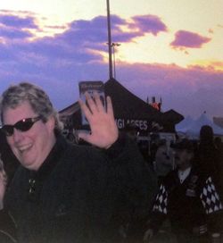 Woman photographing through smart phone at sunset