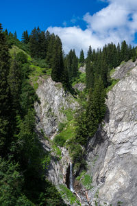 Scenic view of waterfall against sky