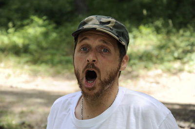 Close-up portrait of man shouting in forest