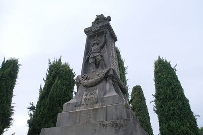 Low angle view of statue against sky