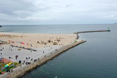 People on beach against sky