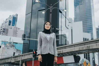 Portrait of woman standing in city