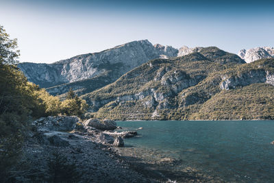 Scenic view of sea and mountains against sky