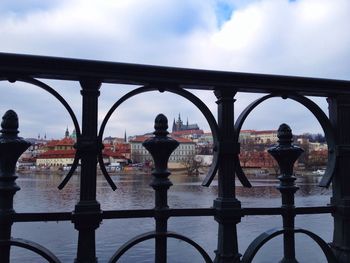 Bridge over river against cloudy sky