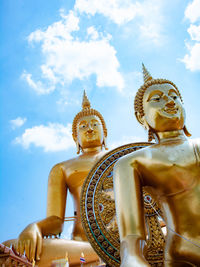 Low angle view of statue against temple against sky