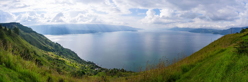 Panoramic view of land and mountains against sky