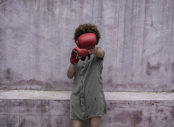 Full length of woman wearing boxing gloves