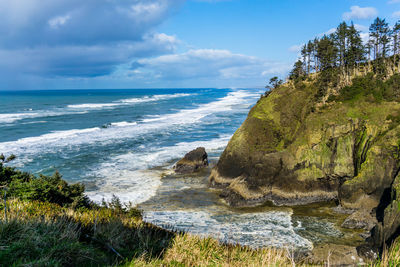 Waves pound the shoreline rocks at cape disappointment in washington state.