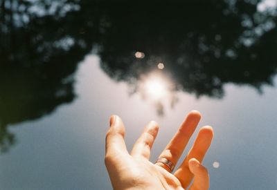 Midsection of person against sky in water