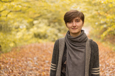 Portrait of young woman in autumn leaves