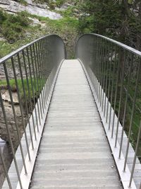 Empty footbridge along footpath