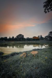 Scenic view of lake against sky during sunset