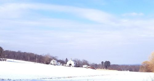 Snow covered field against sky