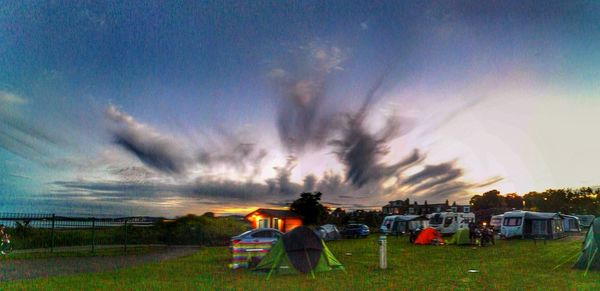 View of grassy field against cloudy sky