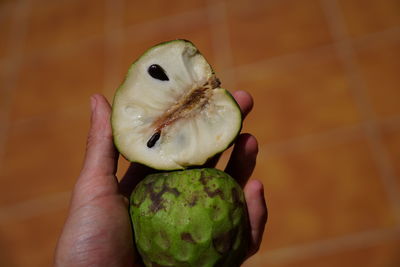Close-up of hand holding fruit