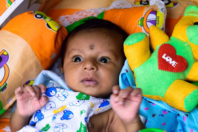 Close up portrait of cute newborn baby looking at camera. indian ethnicity. high angel view.