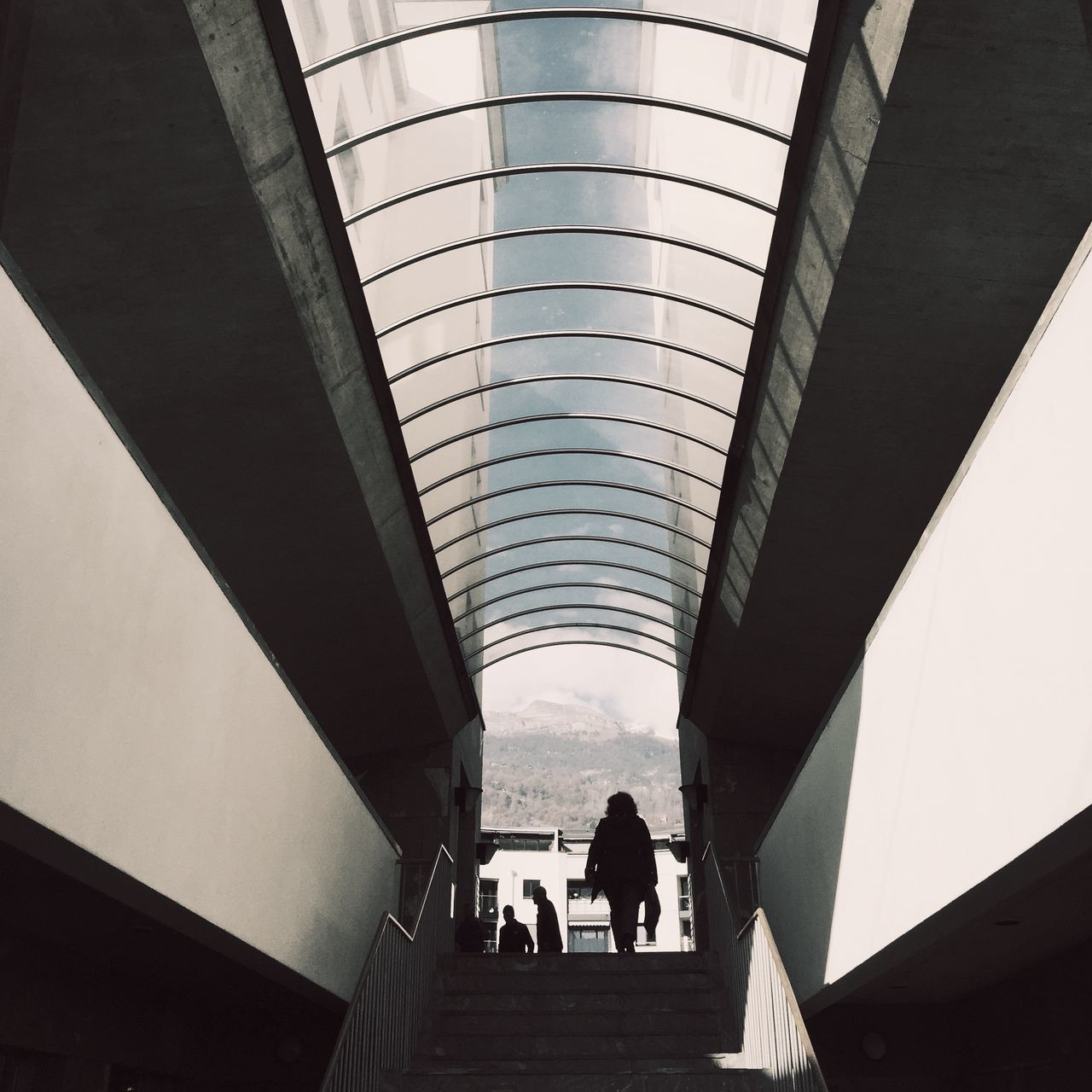 indoors, architecture, built structure, ceiling, men, arch, walking, low angle view, person, lifestyles, travel, diminishing perspective, famous place, the way forward, architectural column, incidental people, travel destinations, tourism, leisure activity