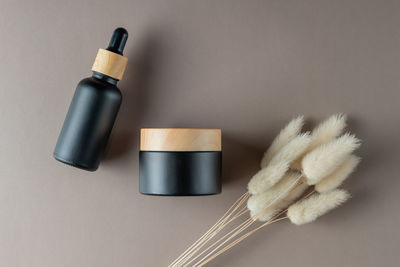 Black frosted glass dropper bottle and face cream jar with bamboo lid 