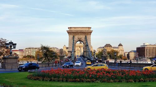 View of monument in city against cloudy sky