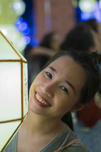 Close-up portrait of smiling young woman