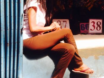 Rear view of man sitting on bench