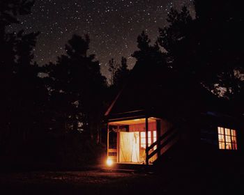 Illuminated house against sky at night