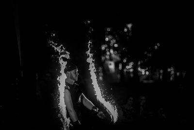 Side view of people dancing at night