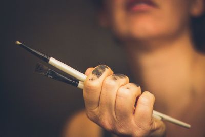 Midsection of woman smoking cigarette