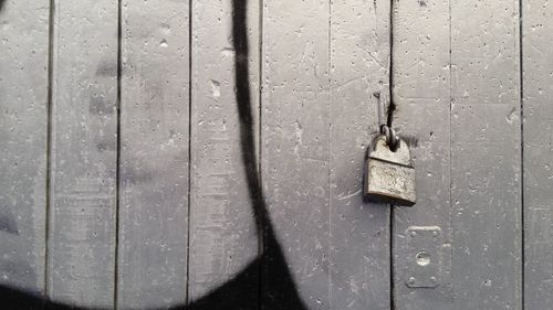 Close-up of rusty padlock on door
