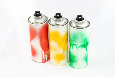 Close-up of multi colored pencils on table against white background