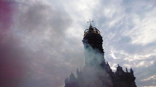 Low angle view of statue against cloudy sky