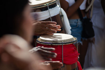 Percussionist hands playing atabaque.
