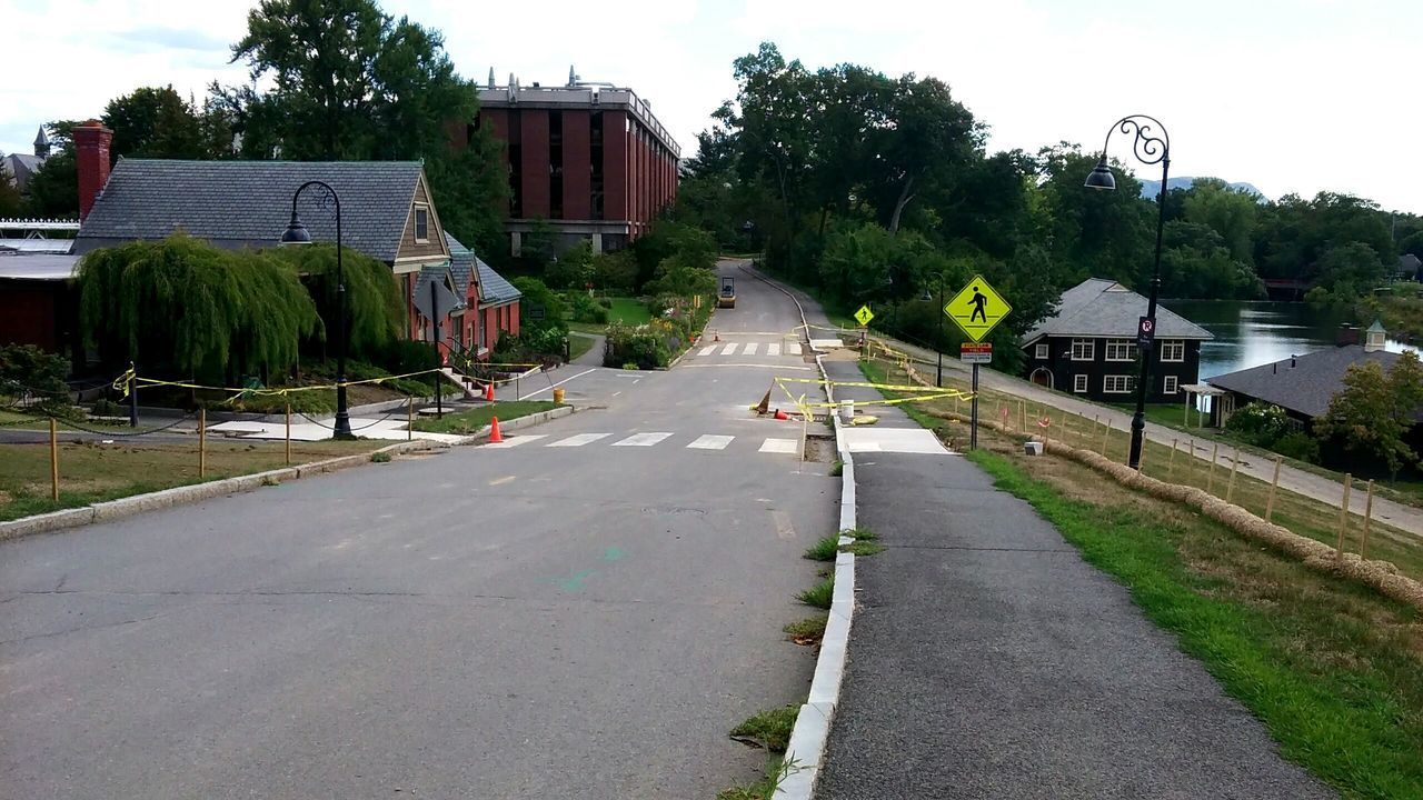 ROAD AMIDST BUILDINGS AND HOUSES