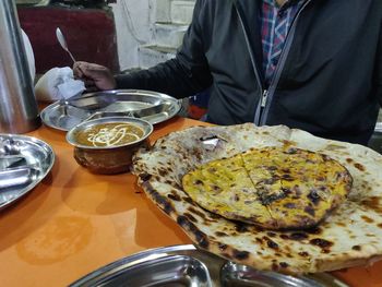 Midsection of man having food in restaurant