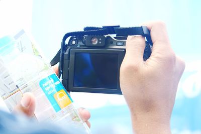 Cropped image of man holding smart phone