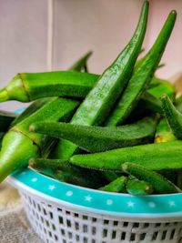 Close-up of green chili peppers in basket