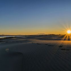 Scenic view of sea against clear sky during sunset