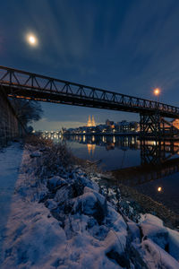 View of bridge over river at night